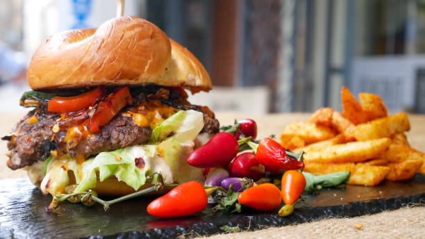 istock Meaty hamburger and fries on a table 1190806594