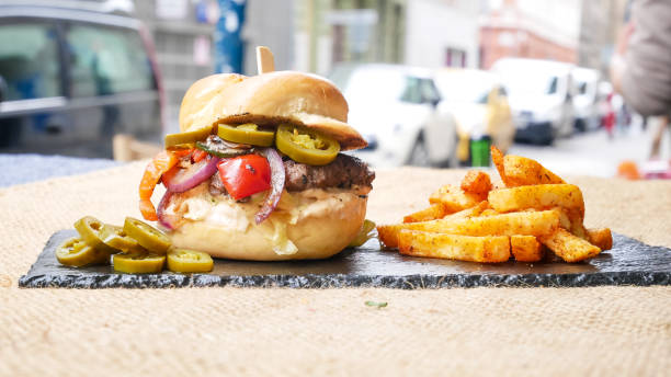 istock Meaty hamburger and fries on a table 1190806620