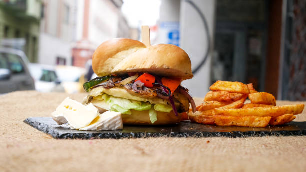 istock Meaty hamburger and fries on a table 1190806684