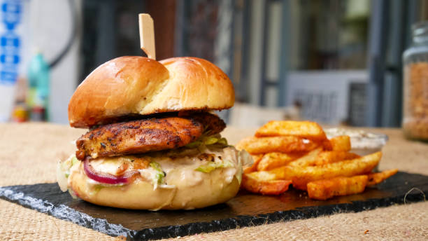 istock Meaty hamburger and fries on a table 1190806736