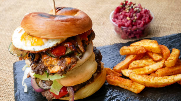 istock Meaty hamburger and fries on a table 1190806753