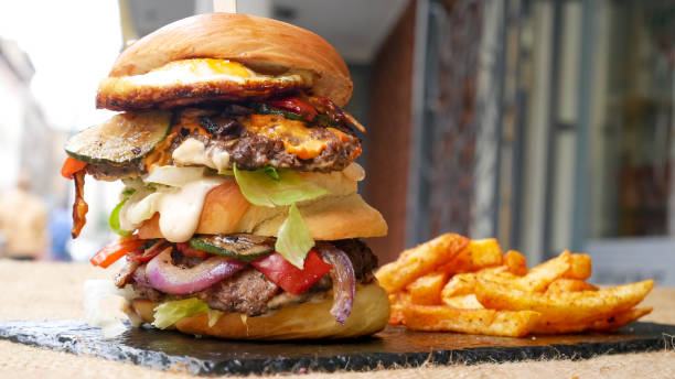 istock Meaty hamburger and fries on a table 1190806795