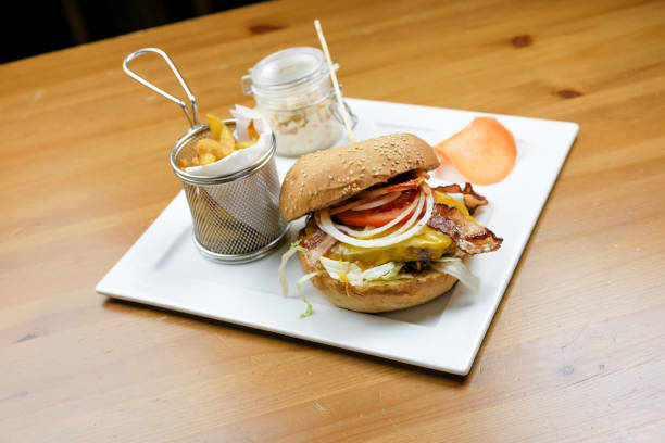 istock Meaty hamburger and fries on a table 1190807422