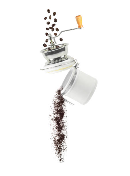 Coffee beans and ground powder falling from manual grinder Coffee beans and ground powder falling from manual grinder. Ingredient for hot drink isolated on white background coffee grinder stock pictures, royalty-free photos & images