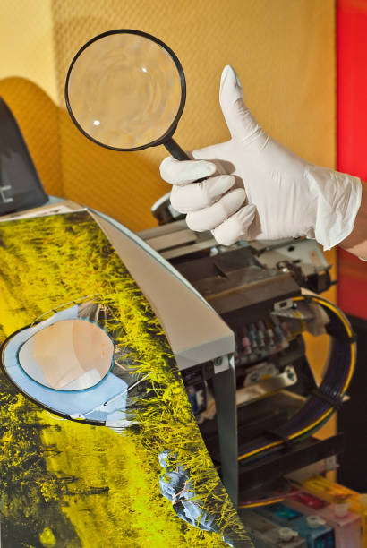 the girl in a white shirt prints a photo. woman looking through photo with magnifier. the assistant checks the printed image. nature, greenery and tent in the photo. - photobusiness imagens e fotografias de stock