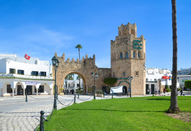 Main gate in Port El Kantaoui, Tunisia Port El Kantaoui, Sousse, Tunisia - October 18, 2018:  The stone gate and tower decorate the entrance to the shopping street and marina. sousse tunisia stock pictures, royalty-free photos & images