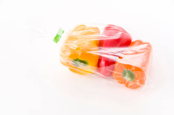 istock fresh Colored bell pepper in plastic bag on white background 1190810978