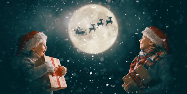 istock children with xmas presents 1190815616