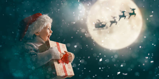 istock girl with present at Christmas 1190815646