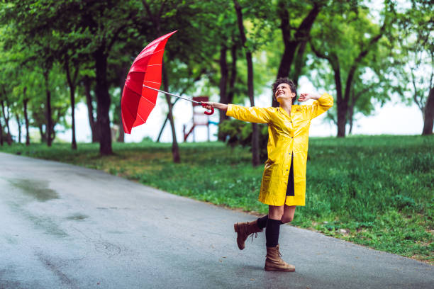 istock Woman in park at rain 1190817826