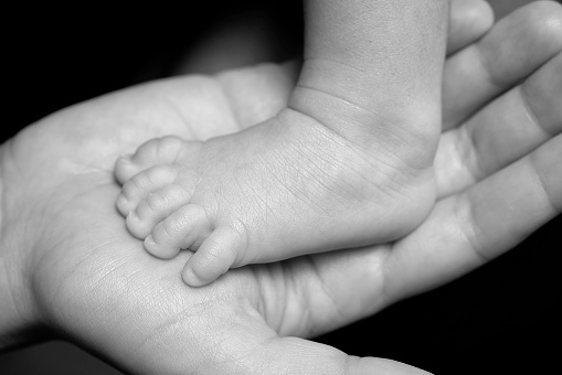 A baby's foot in mother hands