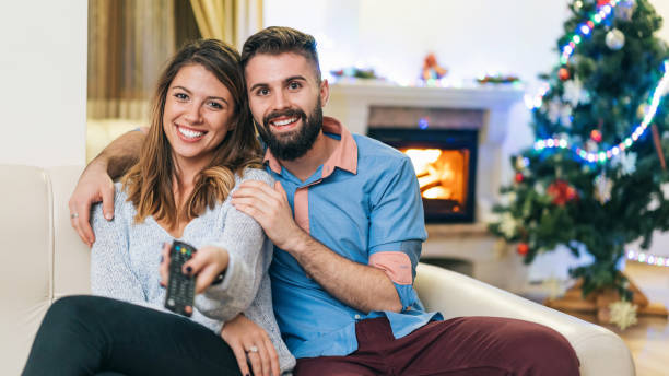 istock Happy couple watching TV at home 1190820659
