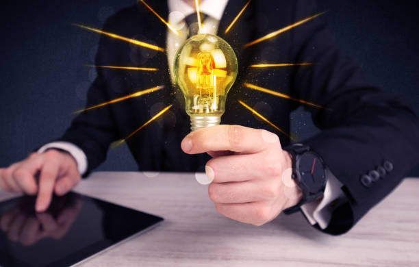 istock business person holding an electric light bulb 1190821863