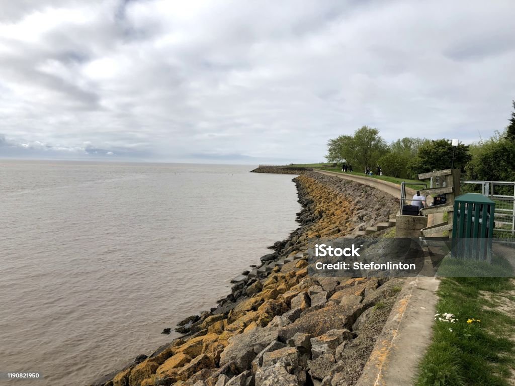 Seawall in Newport, Wales A seawall near the town of Newport, Wales Retaining Wall Stock Photo