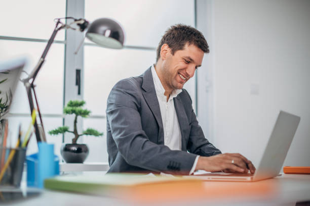 istock Young businessman using laptop at the office 1190823334