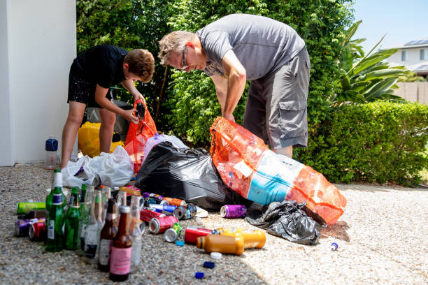 Young Australian boy counts bottles and cans for recycling