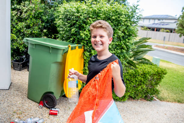 Young Australian boy counts bottles and cans for recycling