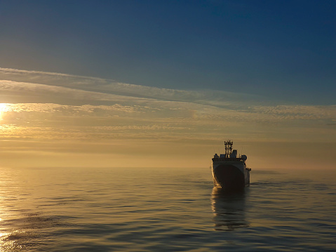 offshore vessel at early morning during very calm seas