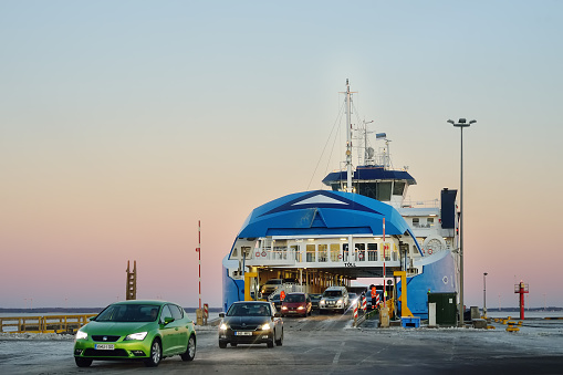 Virtsu, Estonia - January 03 2019: Ferryboat between Virtsu and Kuivastu settlements, Estonia. Cars leaves ferry ship.Travel by sea on ferryships.