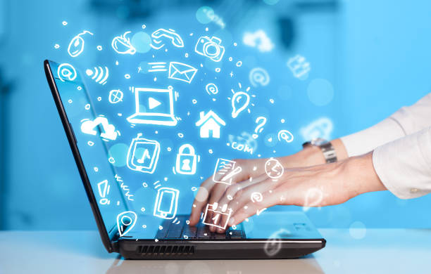istock Hand writing on notebook computer with media icons and symbols 1190827406