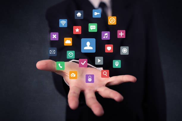 istock Businessman holding colorful applications 1190827580