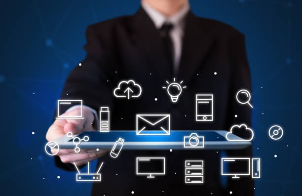 istock Businessman holding tablet with media graphics 1190827677