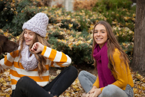 istock Girlfriends having fun in the autumn leaves 1190827774