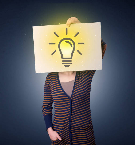 istock Woman holding paper with lightbulb 1190828747