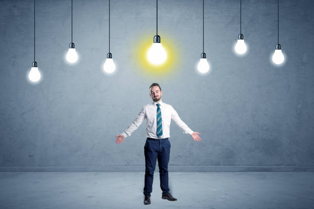 istock Businessman standing uninspired with bulbs above 1190829534