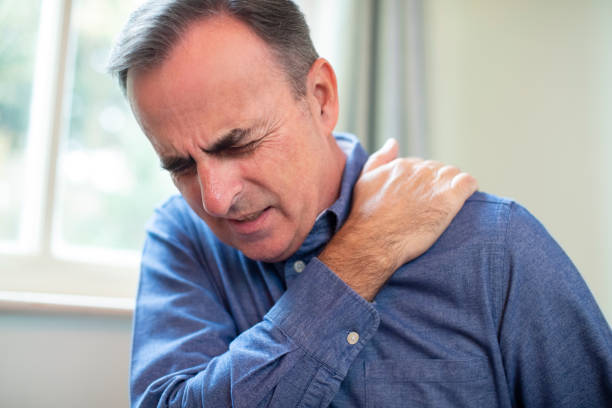 istock Mature Man Suffering With Trapped Nerve In Shoulder At Home 1190832571