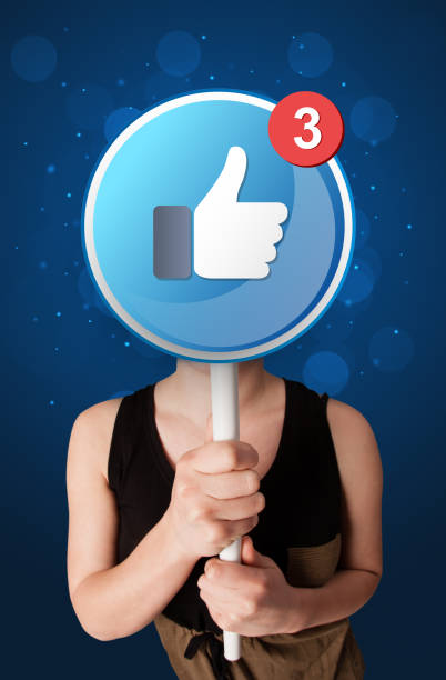 istock Woman holding facebook sign 1190834193