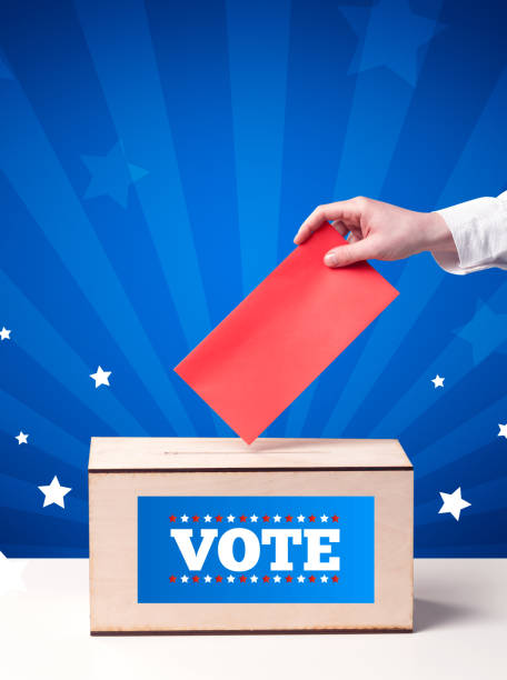 istock hand with ballot and wooden box 1190835091