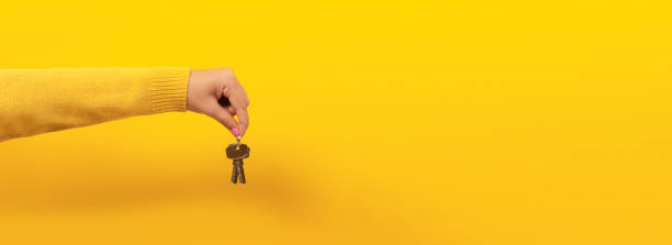 istock hand holding house keys 1190835379