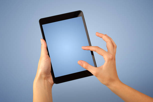 istock Female hand holding tablet 1190836871