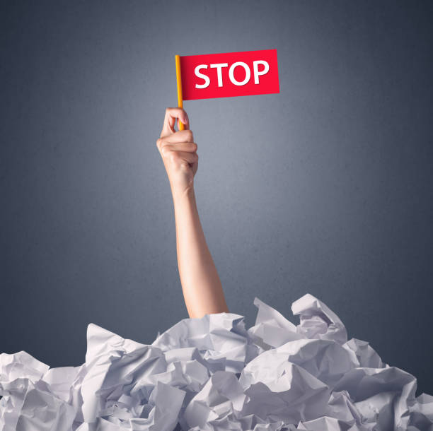 istock Female hand holding stop sign 1190837268