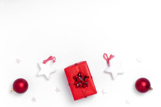 istock New Year and Christmas composition. Frame from red balls, white stars, chrismas tree, deer and sparkles on white background. Top view, flat lay, copy space 1190837392