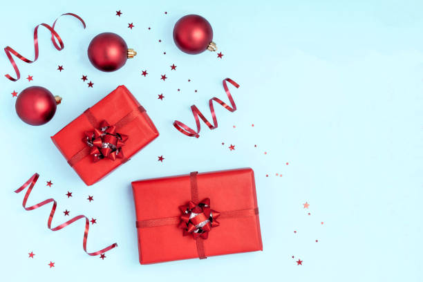 istock New Year and Christmas composition. Frame from red balls, gift boxes and sparkles on pastel blue background. Top view, flat lay, copy space 1190838832