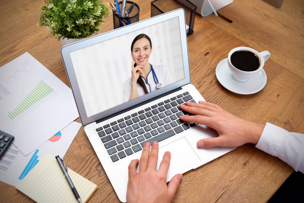 istock Doctor with a stethoscope on the laptop screen 1190839089