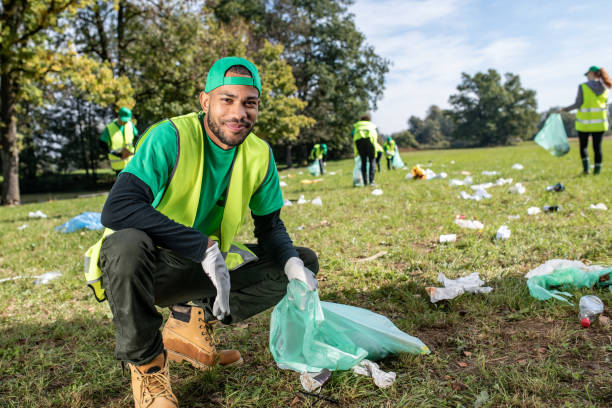 istock Portrait of man crouching with bin bag 1190841136