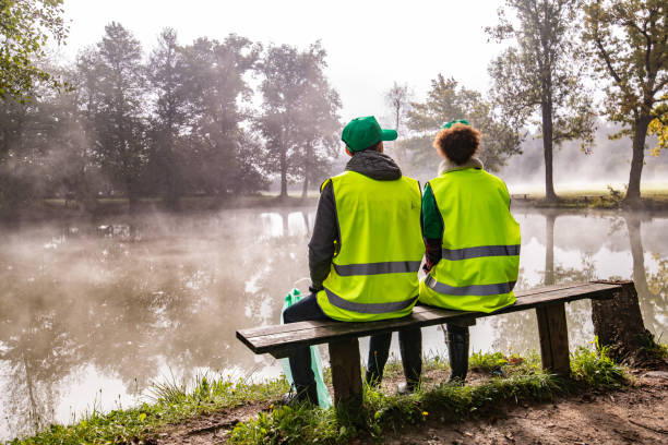 istock Volunteers sitting on bench and looking at view 1190841219
