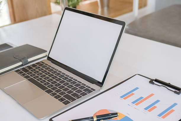 istock Contemporary work space with laptop computer, calculator, office supplies, charts and graphs on wooden table. Business concept. 1190841781