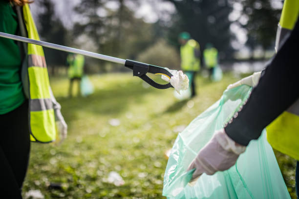 Women collecting rubbish with waste picker