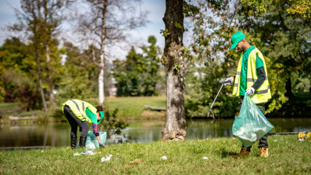 Local cleanup volunteers collecting rubbish in public park.
