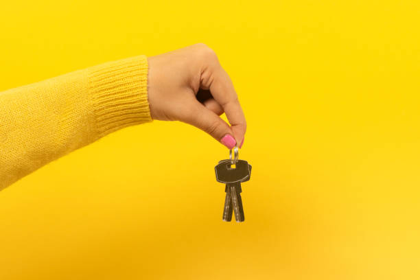 istock hand holding house keys, 1190844382