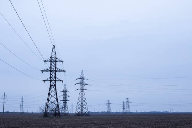 istock electric poles on a field 1190848611