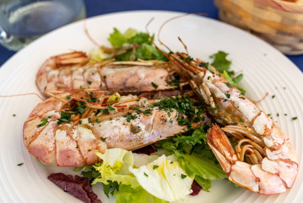 istock fried big shrimps with lettuce on white plate 1190850466