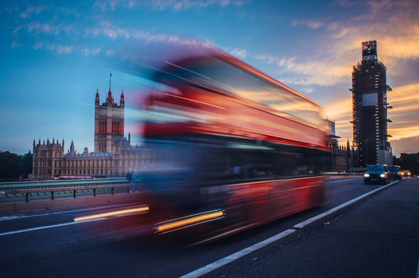 istock London. Classic red double decker bus crossing Westminster Bridge at sunset. 1190854174