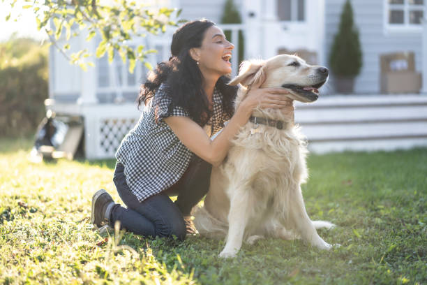istock Woman having fun with her dog  in back yard 1190855499