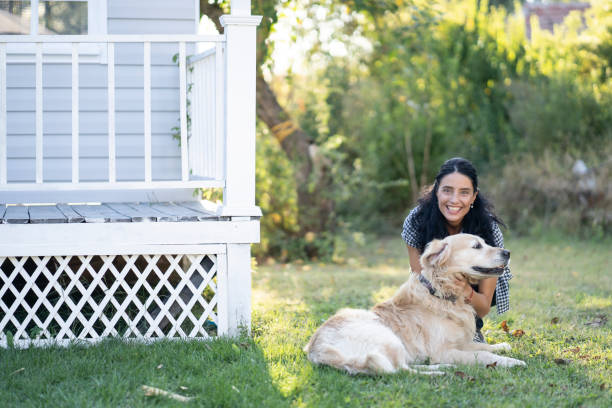 istock Woman having fun with her dog  in back yard 1190855522
