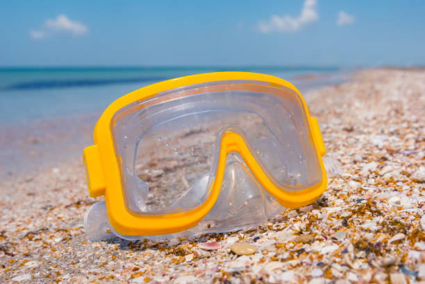 istock closeup diving mask on a sea coast 1190856758